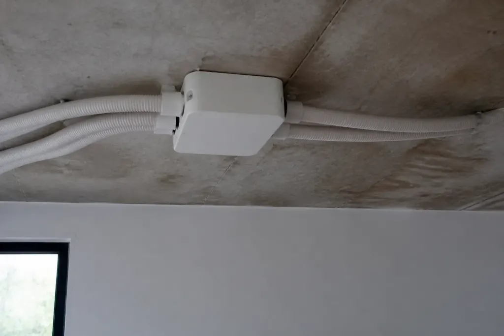 Boitier blanc fixe au plafond avec gaines souples
